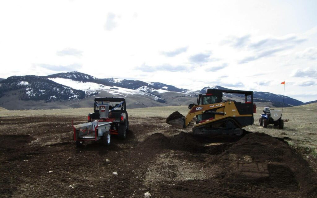 Heavy machinery providing environmental field services of custom seeding and planting.